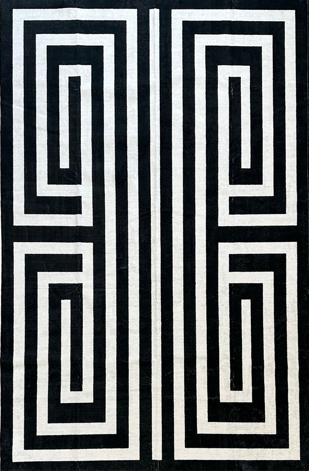 Black and white geometric pattern on a textured fabric background