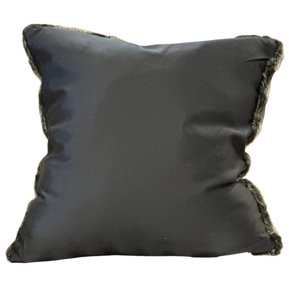 Black pillow with frayed edges on a white background
