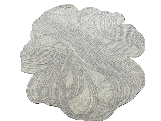 A round area rug with an abstract, organic wavy pattern in light gray and off-white tones, shown against a plain white background.