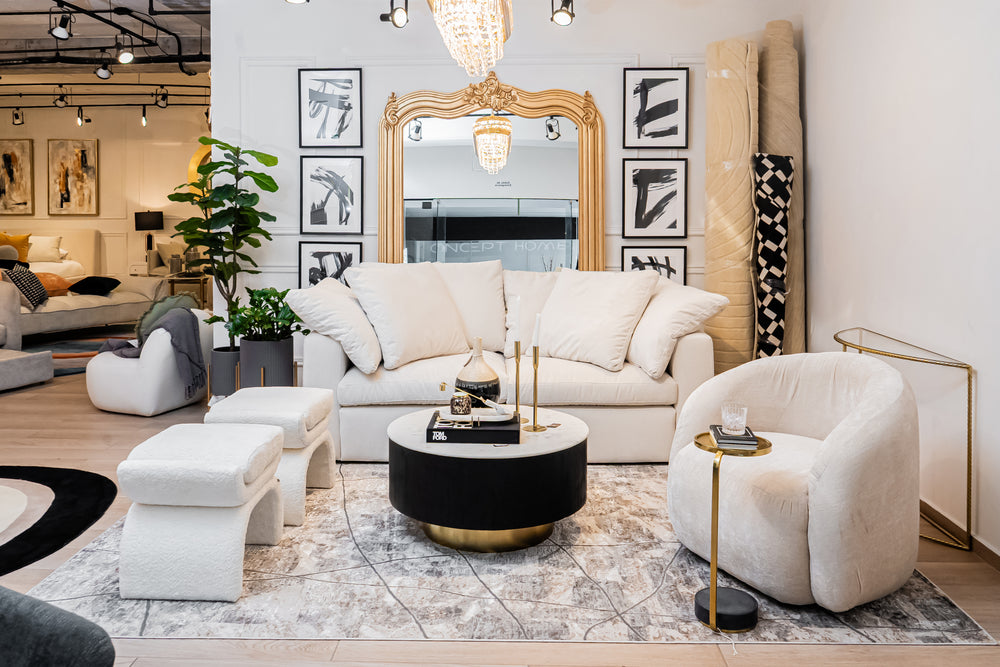 Modern living room with white sofa, armchair, and coffee table in a stylish interior setting.