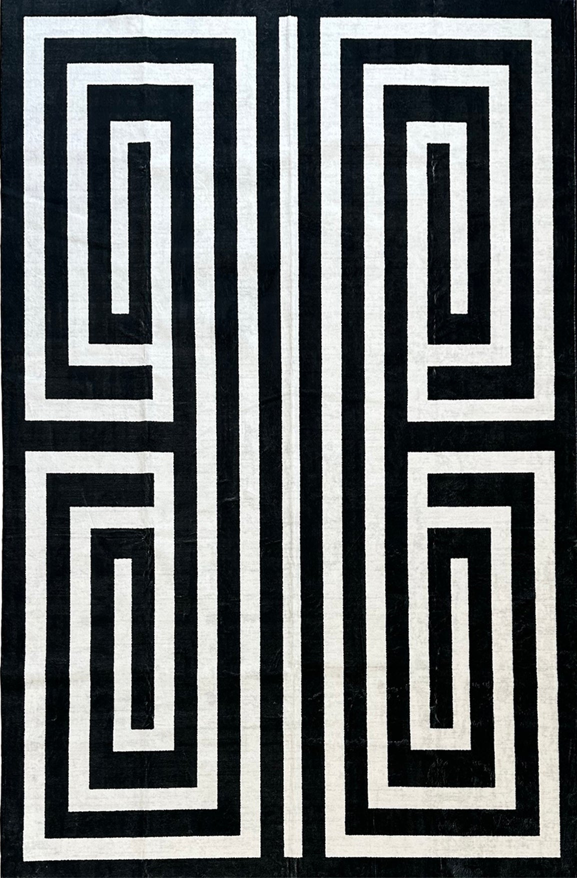 Black and white geometric pattern on a textured fabric background