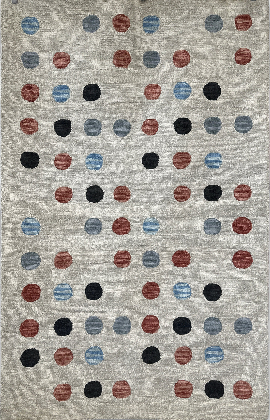 Rug with a pattern of multicolored dots on a neutral background