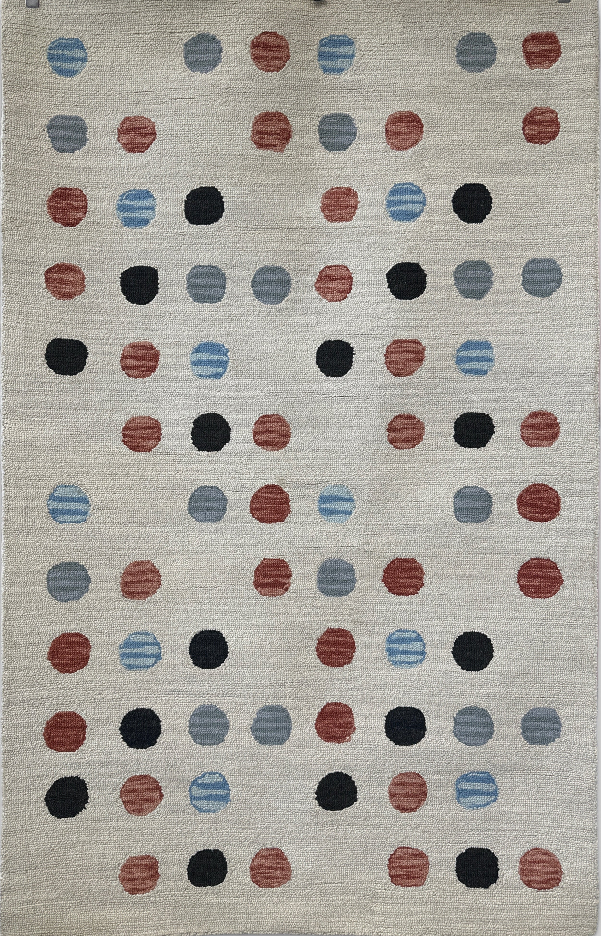 Rug with a pattern of multicolored dots on a neutral background