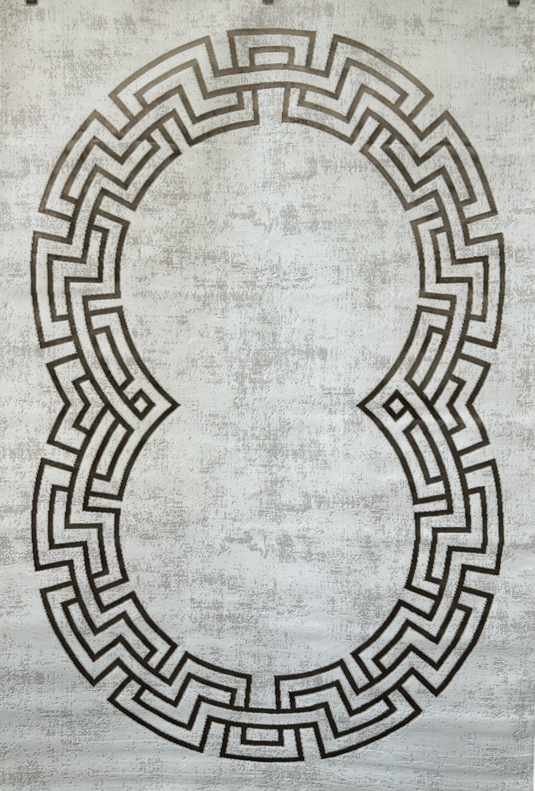Decorative rug with a geometric pattern on a textured surface