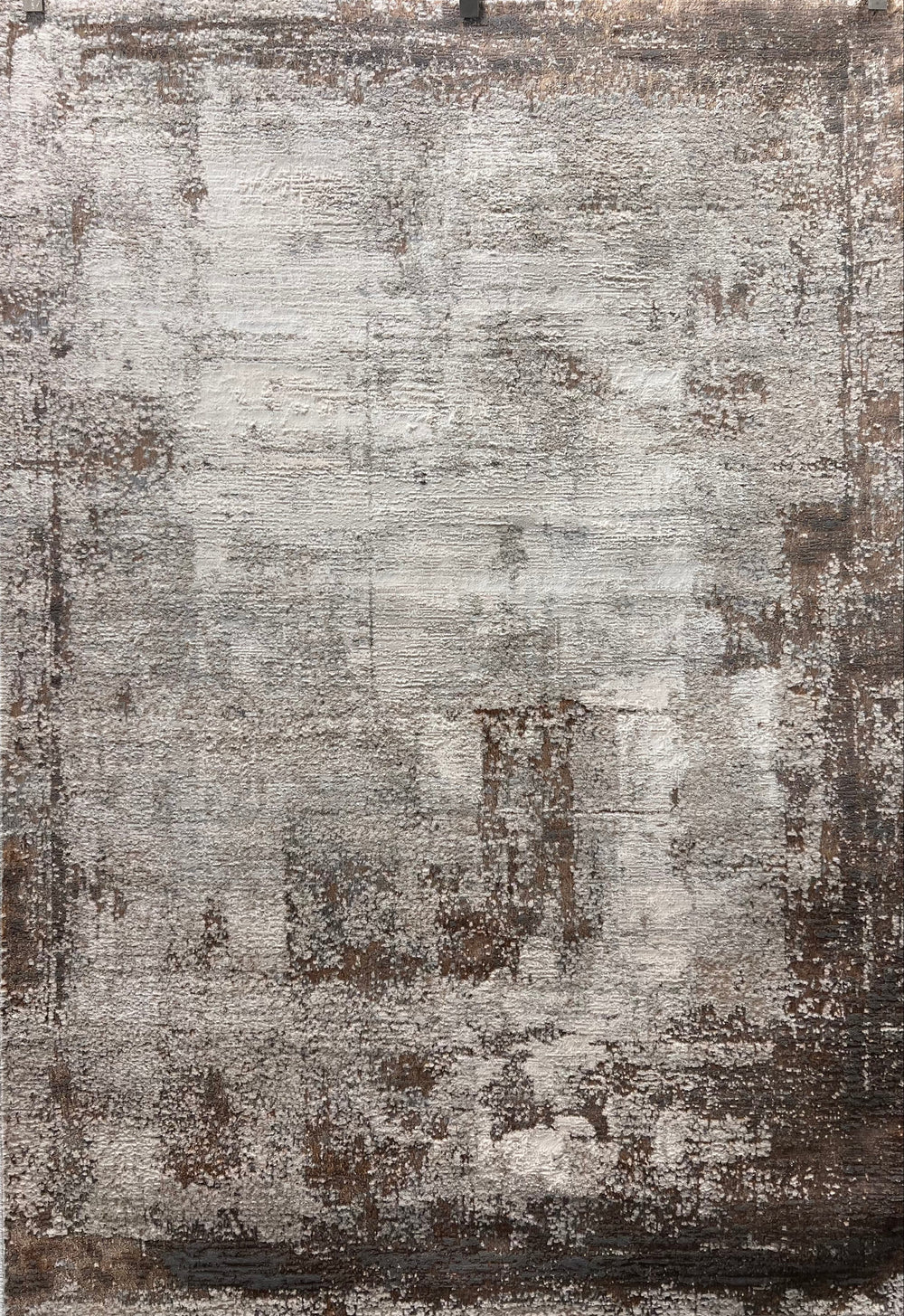 Textured area rug with a mix of brown, gray, and beige colors.