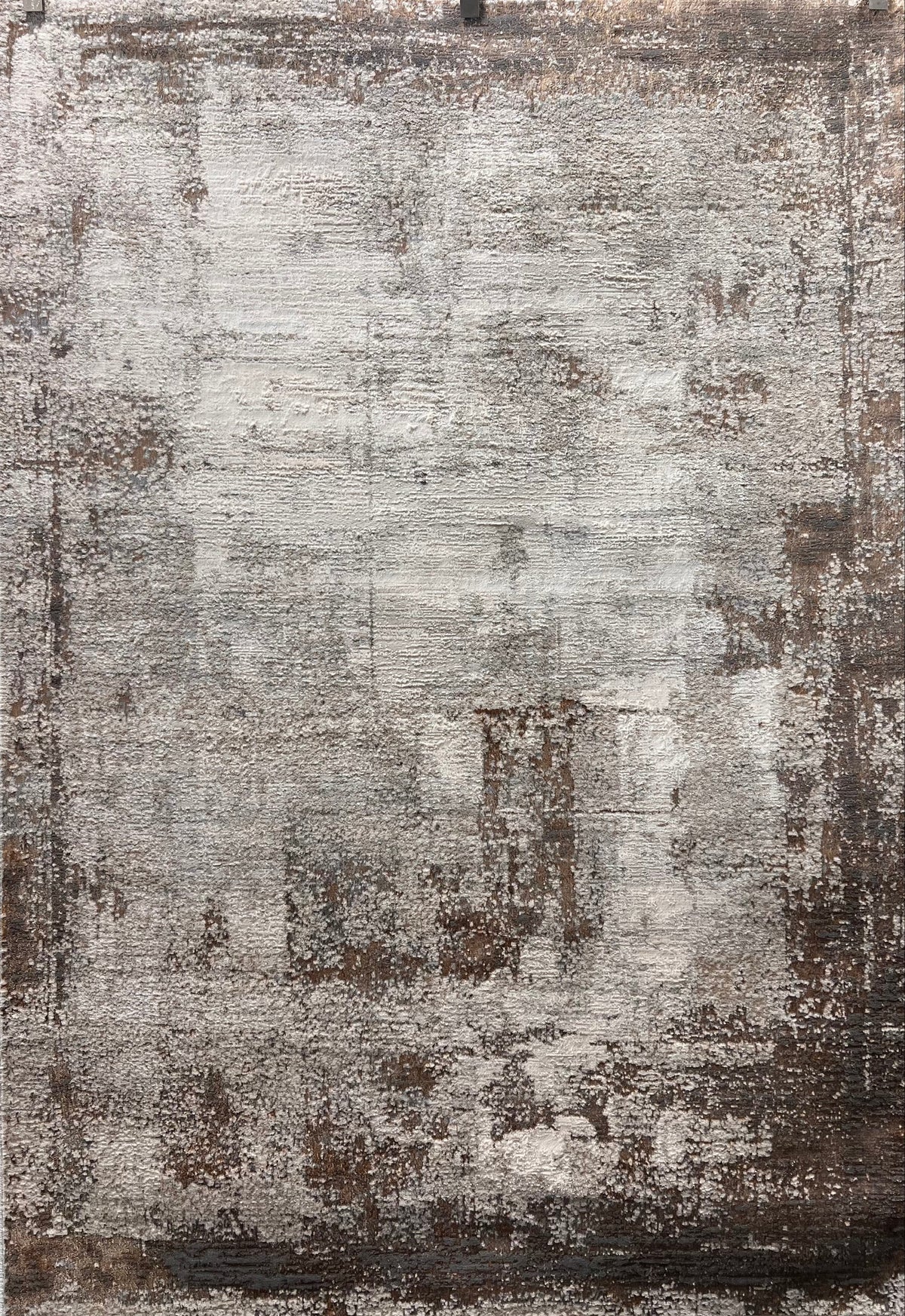 Textured area rug with a mix of brown, gray, and beige colors.