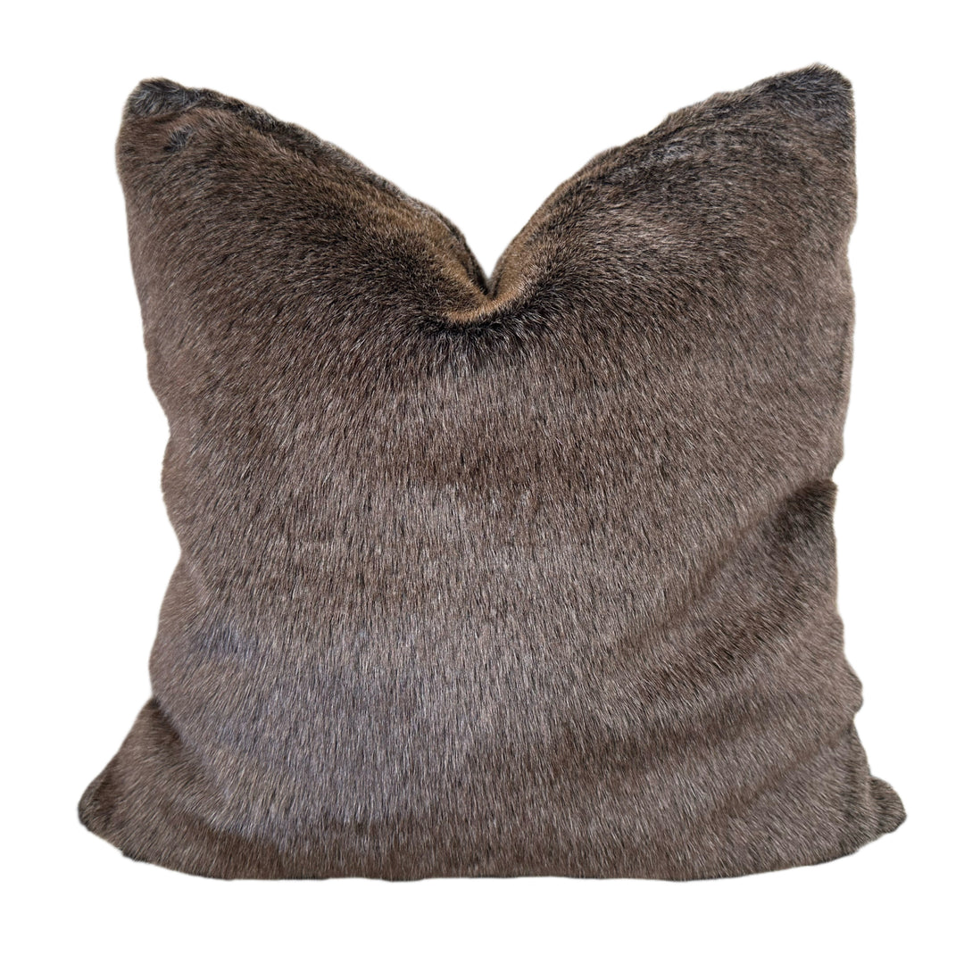 Brown faux fur pillow on a white background