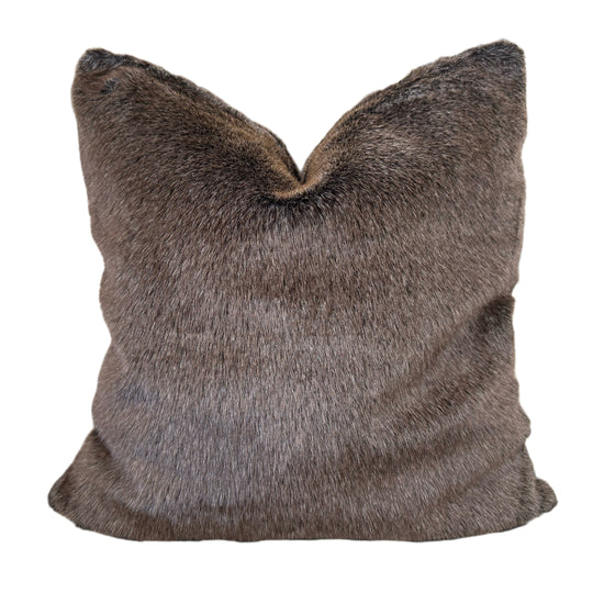 Brown faux fur pillow on a white background