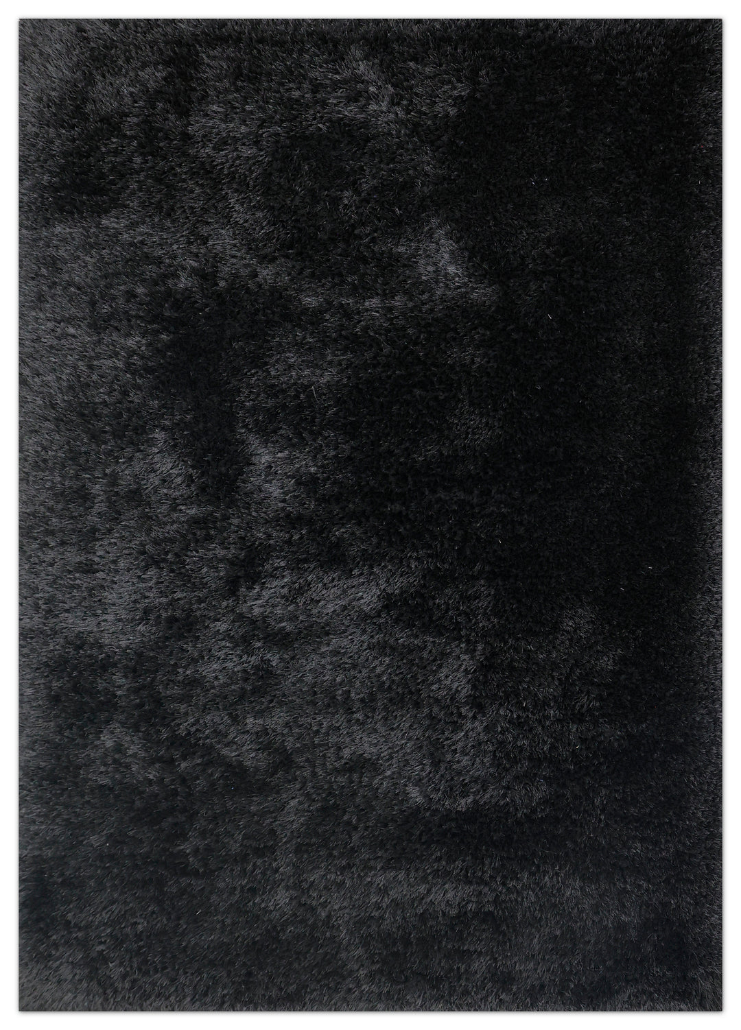 A close-up texture shot of a black shaggy rug, showing the dense pile of the fabric.