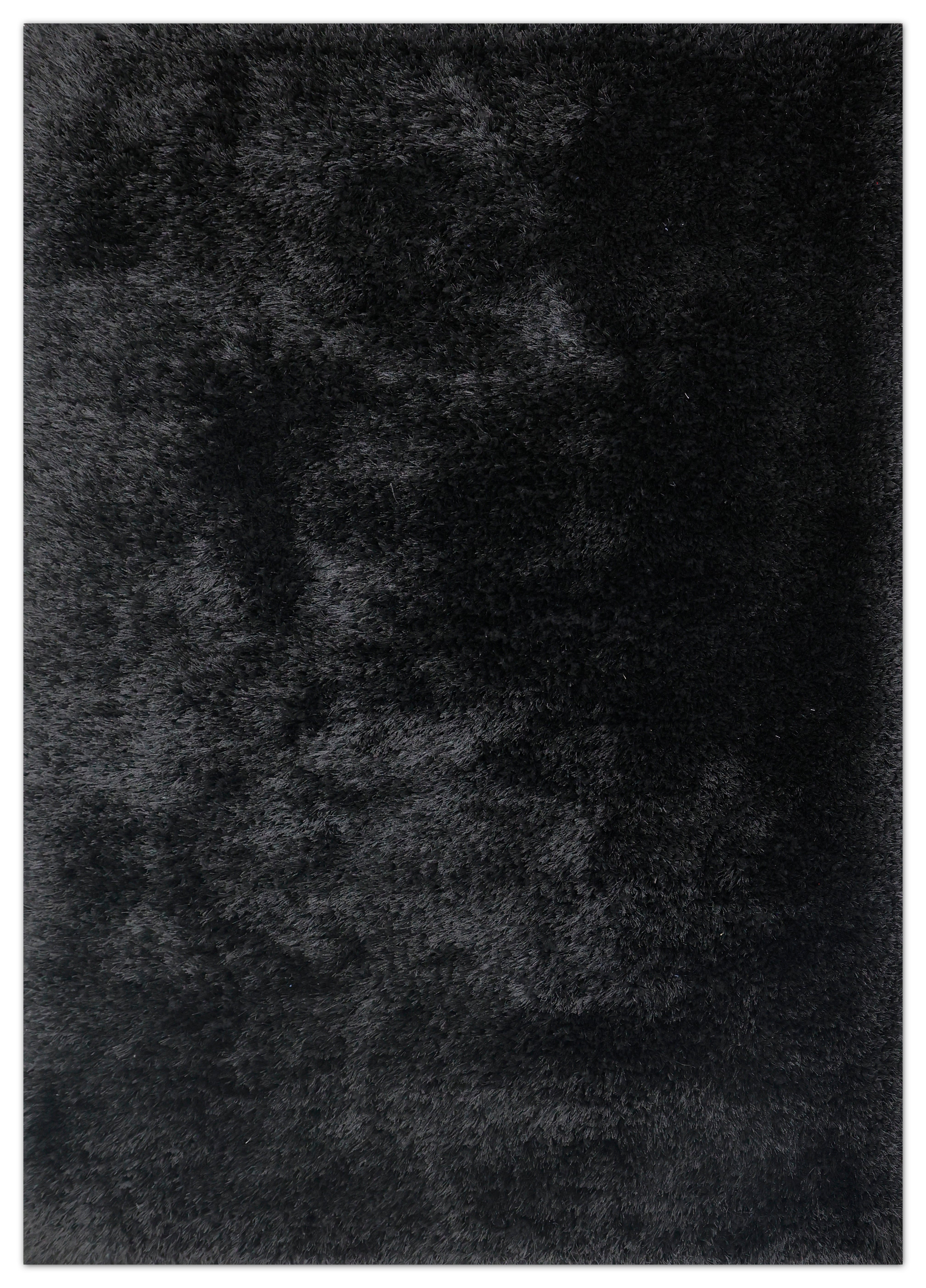 A close-up texture shot of a black shaggy rug, showing the dense pile of the fabric.