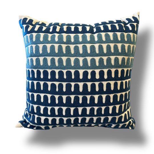 Decorative pillow with blue and white pattern on a white background