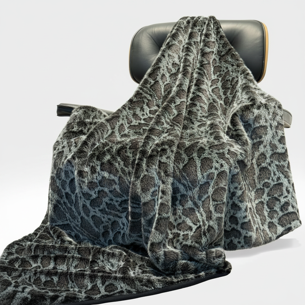 Gray leopard patterned blanket draped over a office chair on a white background