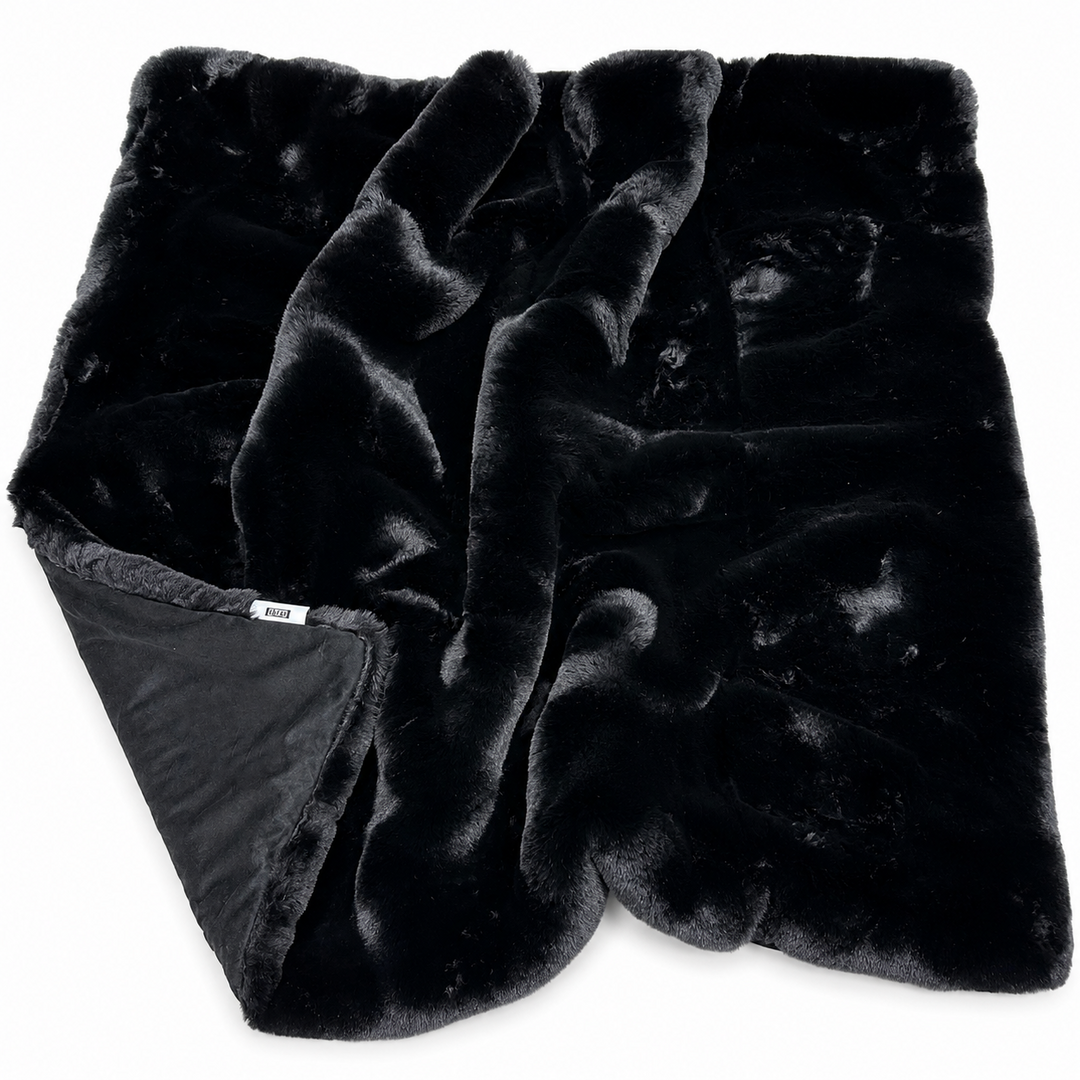 Black plush blanket on a white background
