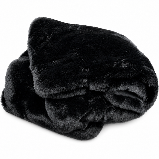 Folded black faux fur blanket on a white background