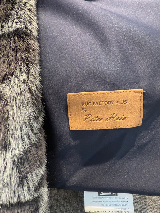 Close-up of a rug with a brand label on a textured surface