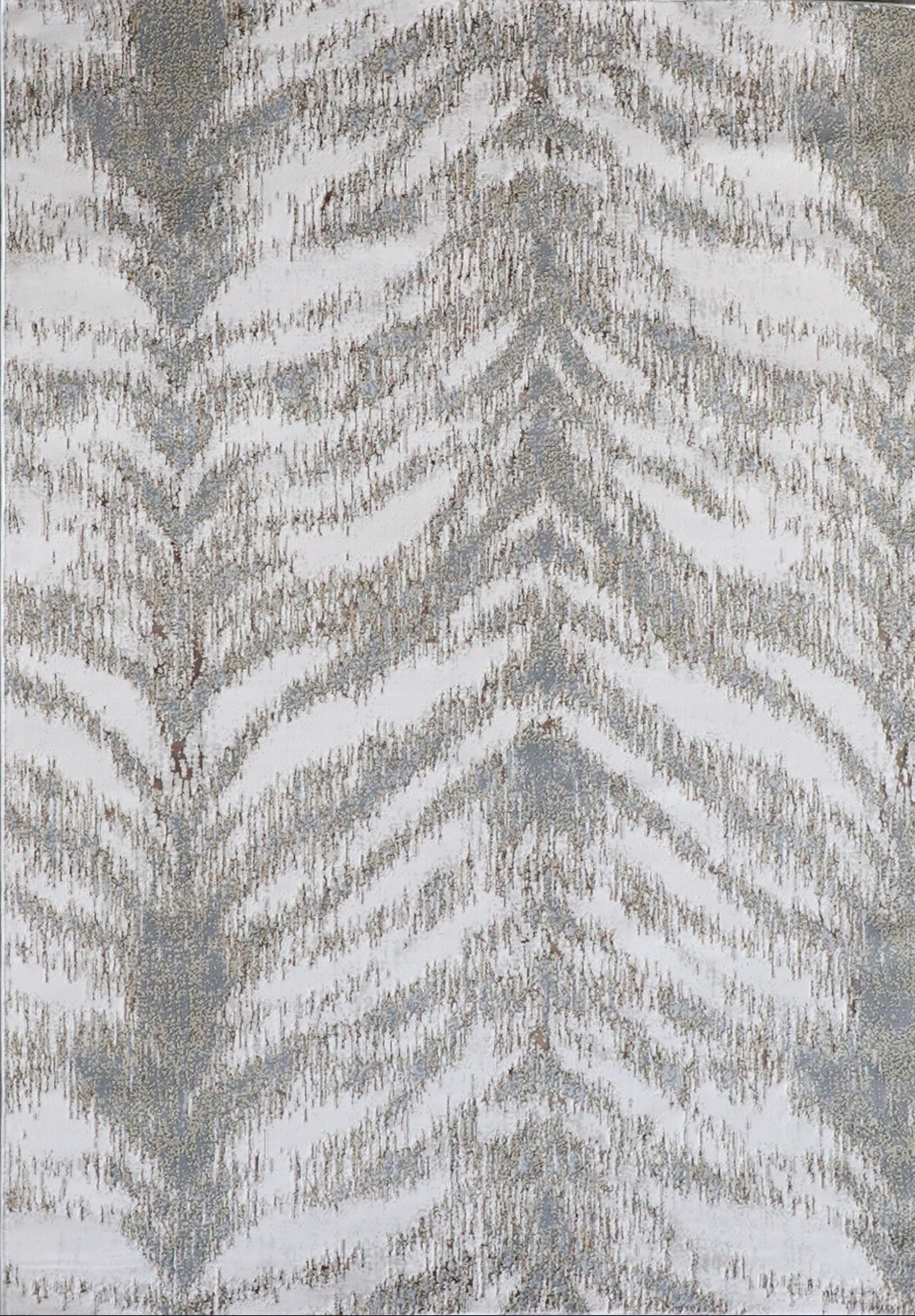 A close-up view of a gray area rug with a geometric pattern showing a zigzag or herringbone design.