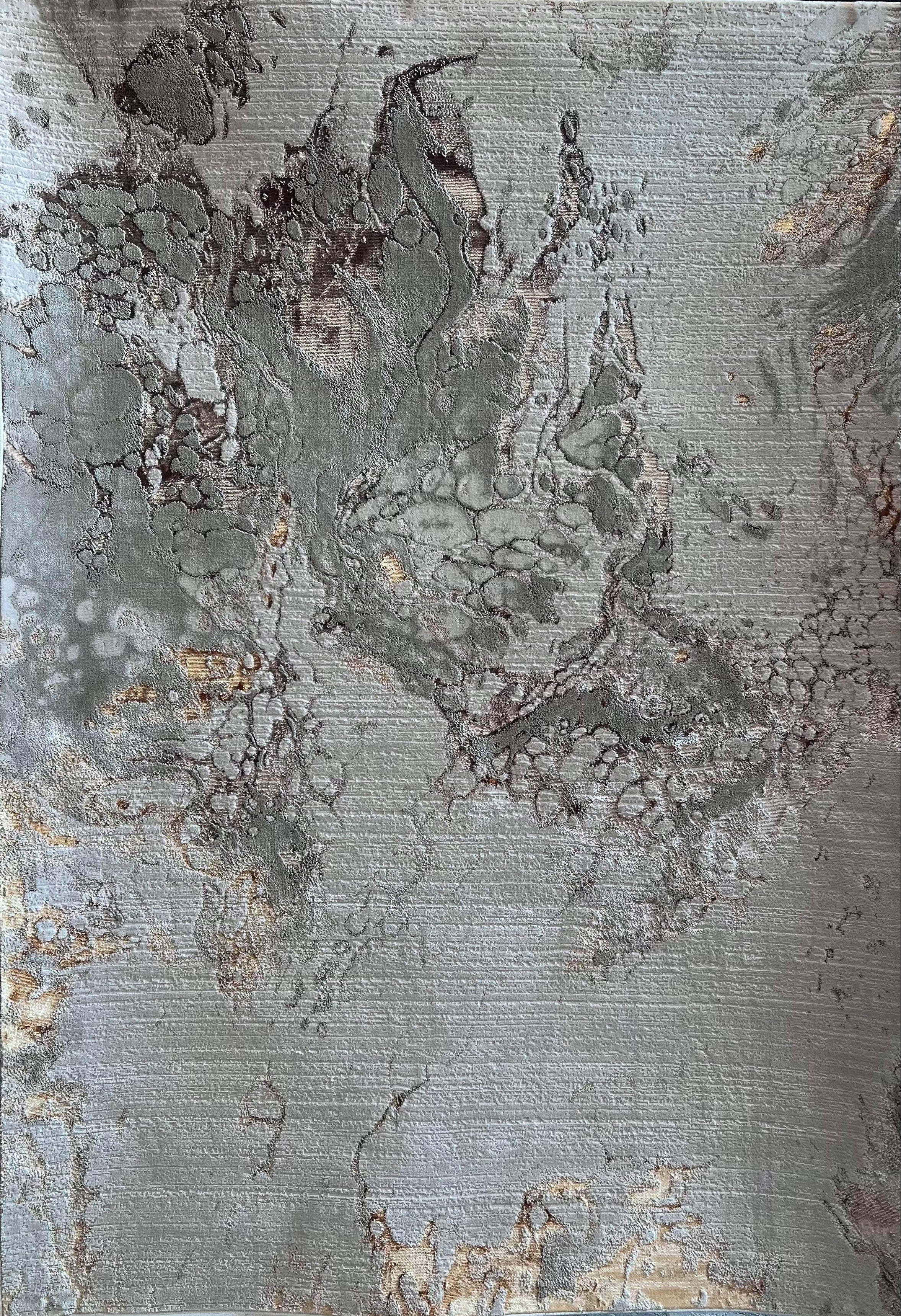 A close-up image of a textured gray and gold rug with a flat weave design.